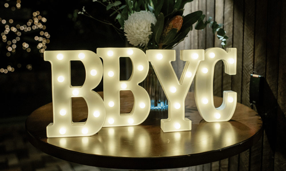 BBYC letters made of lights, sitting on a table