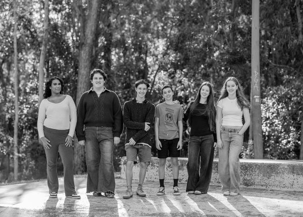 Group of teenagers standing in a line on a skate ramp