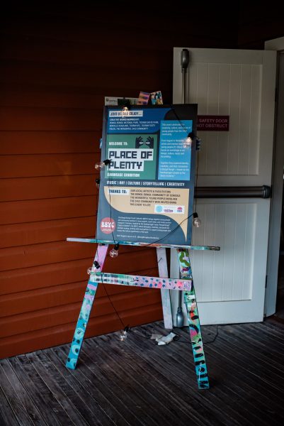 'Place of plenty' sign on easel at front of hall
